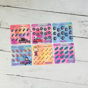 May include: Five square game cards featuring Peanuts characters and automotive icons. Each card displays the text EACH _ OR ROLL A D _ and includes illustrations of bolts, car wheels, gears, or wrenches alongside Snoopy, Charlie Brown, or Lucy.