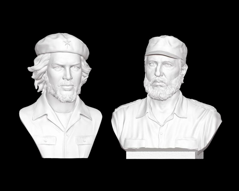 May include: Two white plaster busts of men with facial hair. The man on the left is wearing a beret with a star on it. The man on the right is wearing a cap.