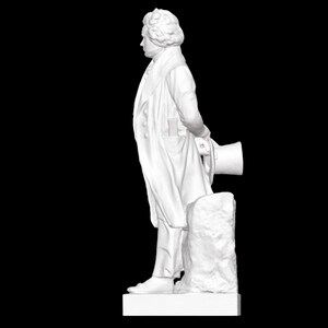 May include: A white marble statue of a man in a long coat, standing with his right hand on a rock and holding a hat in his left hand.