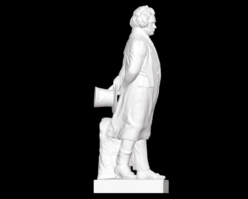 May include: A white marble statue of a man in a coat, holding a top hat in his hand. The statue is standing on a pedestal.