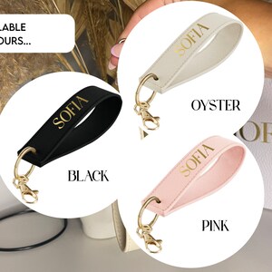 May include: Three leather keychains with gold metal rings and the name "Sofia" in gold lettering. The keychains are in black, oyster, and pink.