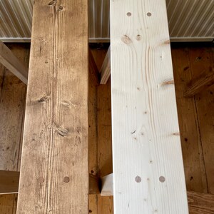 May include: Two wooden benches, one stained a light brown and the other left natural, with visible wood grain and screw holes.