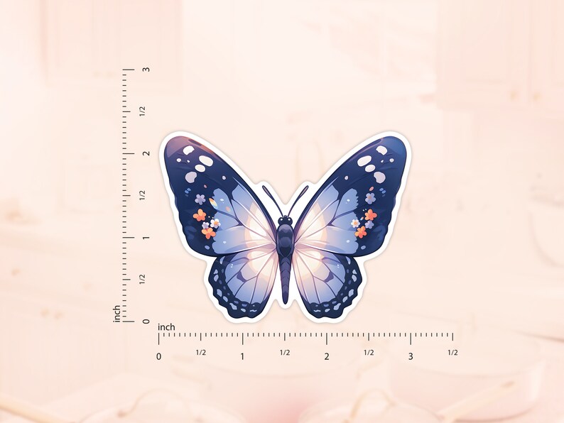 May include: A blue butterfly sticker with white and orange floral accents. The sticker is approximately 5 cm wide.