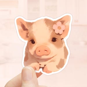 May include: A sticker featuring a cartoon piglet with a pink flower on its head. The piglet has brown spots and is looking directly at the viewer.