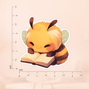 May include: A cute cartoon bee wearing a yellow and black striped body with brown legs and wings is reading a book. The bee has a happy expression on its face and is holding the book with its paws.