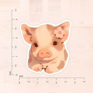 May include: A close-up of a small piglet with a pink flower on its head. The piglet is light pink with brown spots and has a sweet expression on its face.