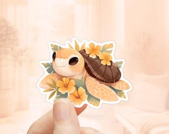May include: A sticker featuring a cartoon sea turtle with a brown shell, surrounded by yellow flowers and green leaves. The turtle has a light orange body and a cute expression.