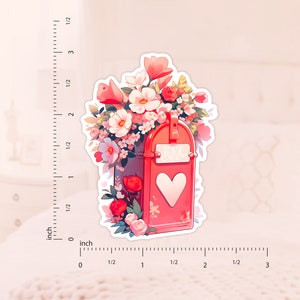 May include: A red mailbox with a heart-shaped opening and the words "Love Letters" on the front. The mailbox is overflowing with pink, white, and red flowers.