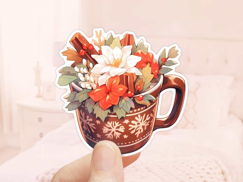 May include: A brown ceramic mug with a snowflake pattern filled with a festive arrangement of white and red flowers, cinnamon sticks, and green leaves.