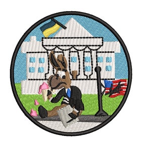 May include: A cartoon donkey wearing a suit and tie sits on the sidewalk in front of the White House, eating ice cream. The donkey is holding a flag with a blue background and a yellow star. The White House is white with blue windows and a blue roof. There is a green lawn in front of the White House.