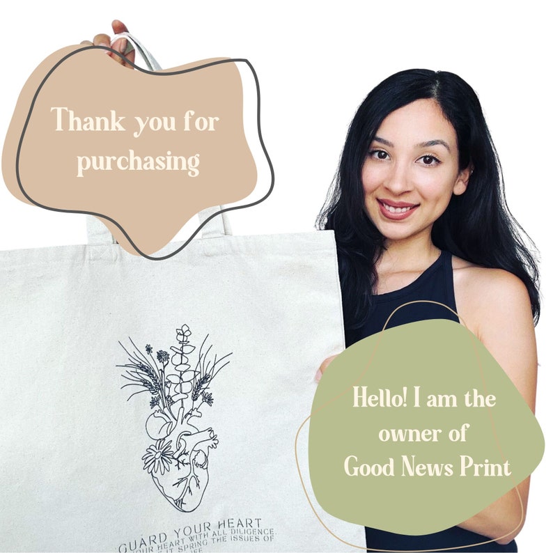 May include: A white tote bag featuring a black line drawing of a heart with flowers and leaves. The text "GUARD YOUR HEART" is below the image. The text "Hello! I am the owner of Good News Print" is in a green speech bubble.