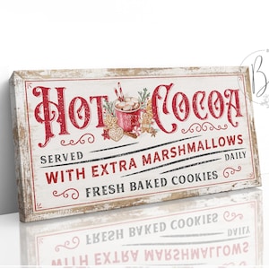 May include: A white wooden sign with red lettering that reads "Hot Cocoa Served With Extra Marshmallows Fresh Baked Cookies Daily". The sign has a vintage look and features a red and white illustration of a mug of hot cocoa with marshmallows.