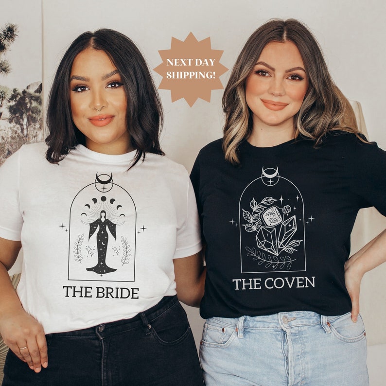 May include: Two women wearing white and black t-shirts with a moon and stars design. The white shirt has the text "The Bride" and the black shirt has the text "The Coven".