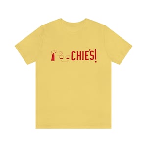 May include: A yellow t-shirt with a red cartoon dog and the text "POOCHIES!" printed on the front.
