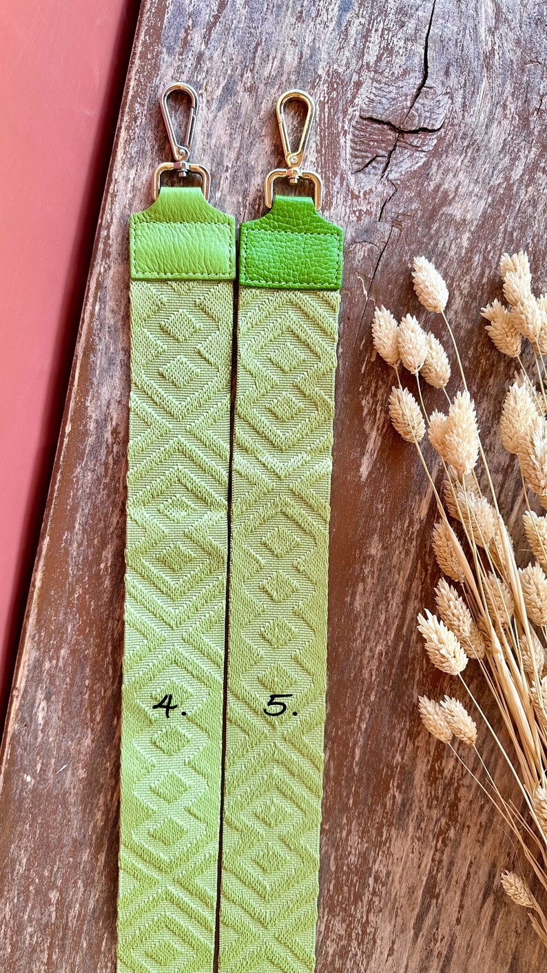May include: Two green woven straps with silver clasps. The straps are labeled "4." and "5."