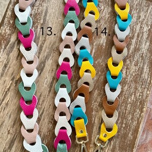 May include: Three colorful purse straps with silver-tone clasps. The straps are made of linked leather pieces in various colors, including pink, green, white, and yellow. The straps are displayed on a wooden surface.