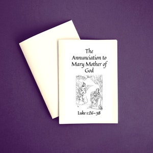 Può includere: Un libretto e una busta color crema su sfondo viola. Il libretto presenta il titolo "The Annunciation to Mary Mother of God" con un'illustrazione e il testo "Luke 1:26-38".