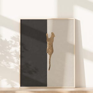 Hand drawn art print of a cheetah climbing vertically in the center of the print. The left side of the print is sold dark grey and the right side is a light tan/beige color.