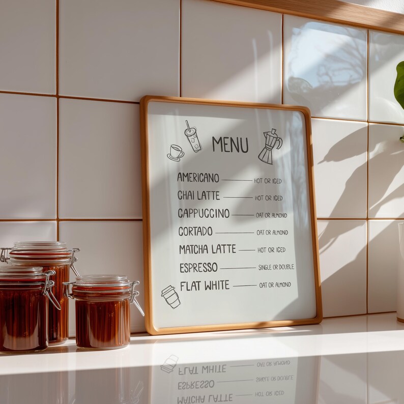 Art print of a drink menu. The list of drinks include; americano, chai latte, cappuccino, cortado, matcha latte, espresso, and flat white. The options next to each drink are; hot or iced, oat milk or almond milk, and single or double.