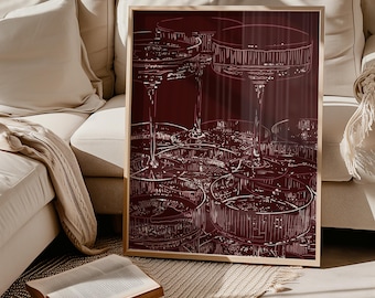 May include: A framed rectangular wall art print featuring a deep burgundy background with white line art illustrations of multiple overlapping champagne coupe glasses. The artwork displays a repeating pattern of stemmed glassware in a graphic style.