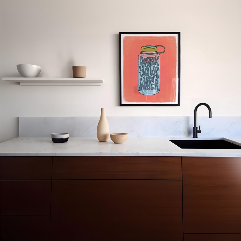 Art print of a water bottle that has the works "drink your water" on it in blue. The water bottle lid is green and the background is salmon pink.