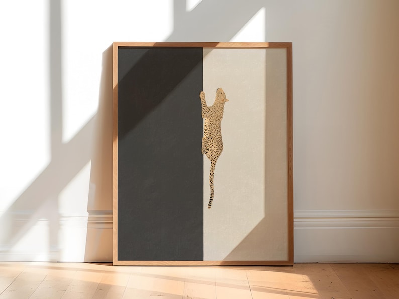 Hand drawn art print of a cheetah climbing vertically in the center of the print. The left side of the print is sold dark grey and the right side is a light tan/beige color.