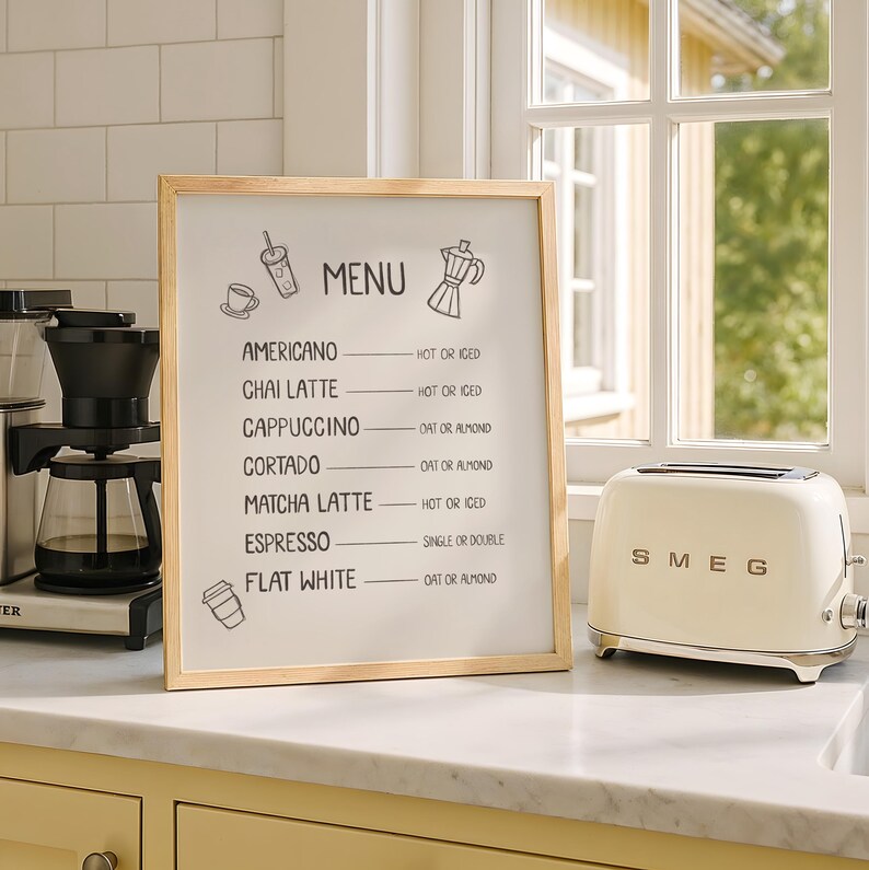 Art print of a drink menu. The list of drinks include; americano, chai latte, cappuccino, cortado, matcha latte, espresso, and flat white. The options next to each drink are; hot or iced, oat milk or almond milk, and single or double.
