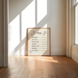 Art print of a drink menu. The list of drinks include; americano, chai latte, cappuccino, cortado, matcha latte, espresso, and flat white. The options next to each drink are; hot or iced, oatmilk or almond milk, and single or double.