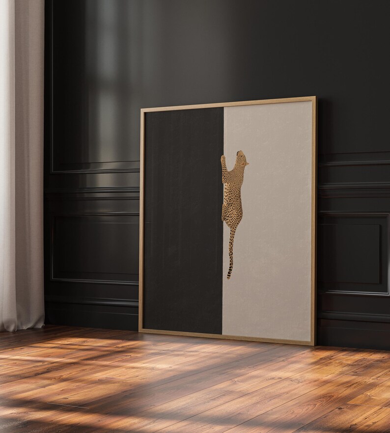 Hand drawn art print of a cheetah climbing vertically in the center of the print. The left side of the print is sold dark grey and the right side is a light tan/beige color.