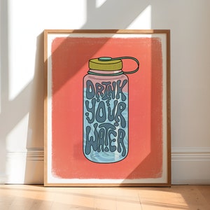 Art print of a water bottle that has the works "drink your water" on it in blue. The water bottle lid is green and the background is salmon pink.
