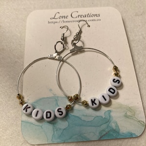 Silver “Kids” hoop earrings