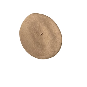 May include: A tan beret hat. The hat is a solid color and has a rounded shape. The beret is made of a soft material and has a small stem on top. The beret is a classic style and can be worn by anyone.