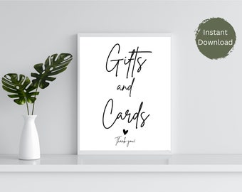 May include: A printable sign with black calligraphy text on a white background. The text reads "Gifts and Cards" with a small heart and "Thank you!" underneath.