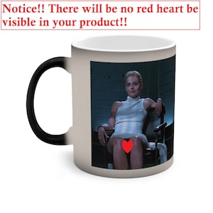 May include: A white ceramic mug with a black handle. The mug features a color image of a woman sitting in a chair. The image is printed on the front of the mug. The mug has a black interior.