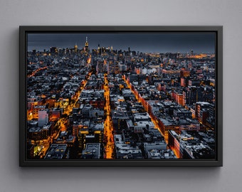 Aerial view of illuminated New York City at night converging towards midtown, framed canvas art print