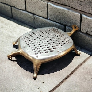 May include: A set of three ceramic mugs with a speckled, matte finish. The mugs are in shades of cream, light gray, and dark gray. Each mug has a simple, minimalist design, perfect for coffee or tea.