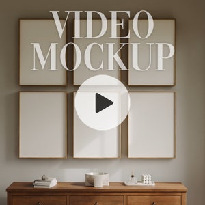 May include: A mockup of a video playing on a wall with five framed pictures. The frames are gold and the wall is a light beige color. The video is playing on a screen in the center of the wall. The video is a play button on a white background.