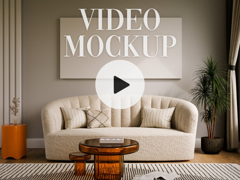May include: A living room interior design mockup featuring a white sofa with pillows, a coffee table with a glass top, a potted plant, and a large white frame with the text "VIDEO MOCKUP" and a play button icon.