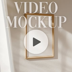May include: A gold-framed picture with a play button icon in the center. The text "VIDEO MOCKUP" is written above the frame.
