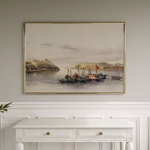May include: A watercolor painting depicting a cityscape with boats on a river. The city is in the background and the boats are in the foreground. The painting is framed in a gold frame.