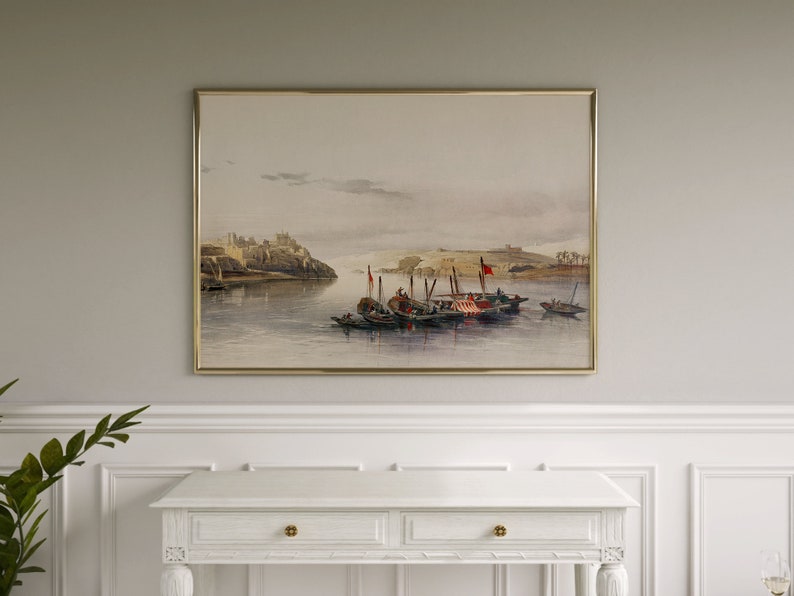 May include: A watercolor painting depicting a cityscape with boats on a river. The city is in the background and the boats are in the foreground. The painting is framed in a gold frame.