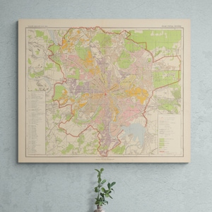 May include: A vintage map of the city of Atlanta, Georgia, printed in black, brown, red, green, yellow, and blue ink on a cream-colored background. The map shows the city's streets, parks, and other features.