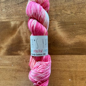 May include: A skein of pink and white yarn with a label that reads "Ma's Yar" and "Comfy Cotton DK".