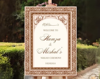 May include: A brown and white wedding sign with an ornate border and Arabic calligraphy. The sign reads "Welcome to Humza & Mishal's Nikkah Ceremony 10|20|2024".