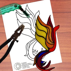 May include: A stained glass pattern for a firebird with a black outline on white paper. The pattern is 4 inches by 9.75 inches and is 100%.