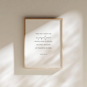 May include: A framed print with a white background and black text. The text reads "Thou wilt keep him in perfect peace whose mind is stayed on thee: because he trusteth in thee." The text is followed by "Isaiah 26:3 KJV".