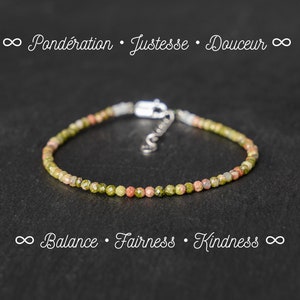 May include: A delicate bracelet made with small green, pink, and white gemstone beads. The bracelet has a silver clasp and is on a black background. The text "∞ Balance · Fairness · Kindness ∞" is below the bracelet.