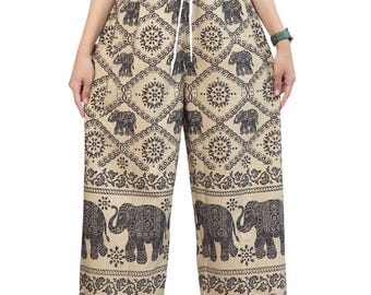 May include: Beige wide-leg pants with a black elephant print. The pants have a drawstring waist and a relaxed fit.
