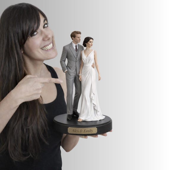 A hand-painted custom figurine sculpted from your photo — two tiny lifelike versions of a couple, made by a real artist's hands.