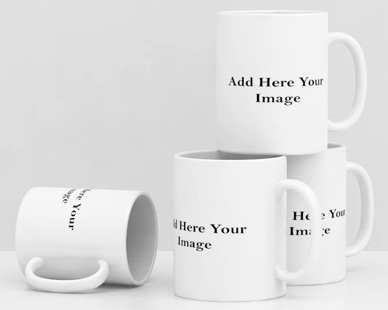 May include: Four white ceramic mugs with black text that reads "Add Here Your Image".